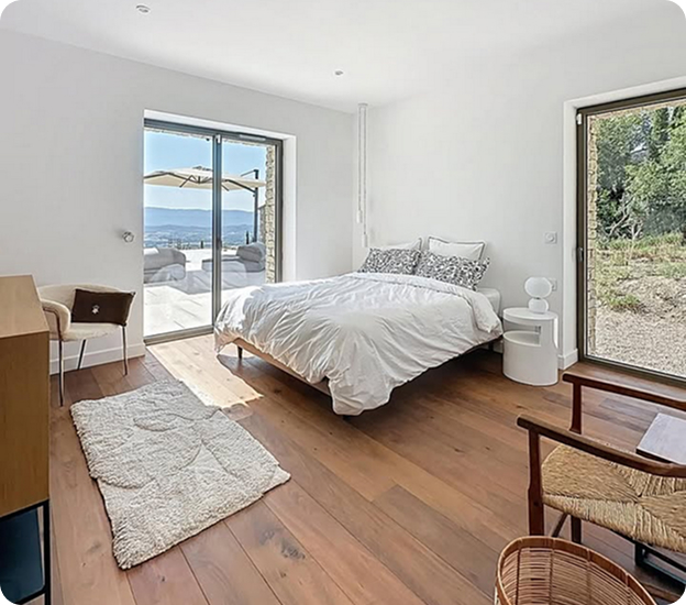 pose de parquets Chambre lumineuse avec grand lit, vue sur la terrasse et paysage vallonné à Saint-Nazaire-de-Pezan près de Montpellier dans l'Hérault 34