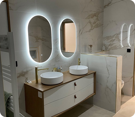 Salle de bain moderne avec double vasque en bois sombre, miroirs ovales et douche vitrée à Saint-Nazaire-de-Pezan près de Montpellier dans l'Hérault 34
